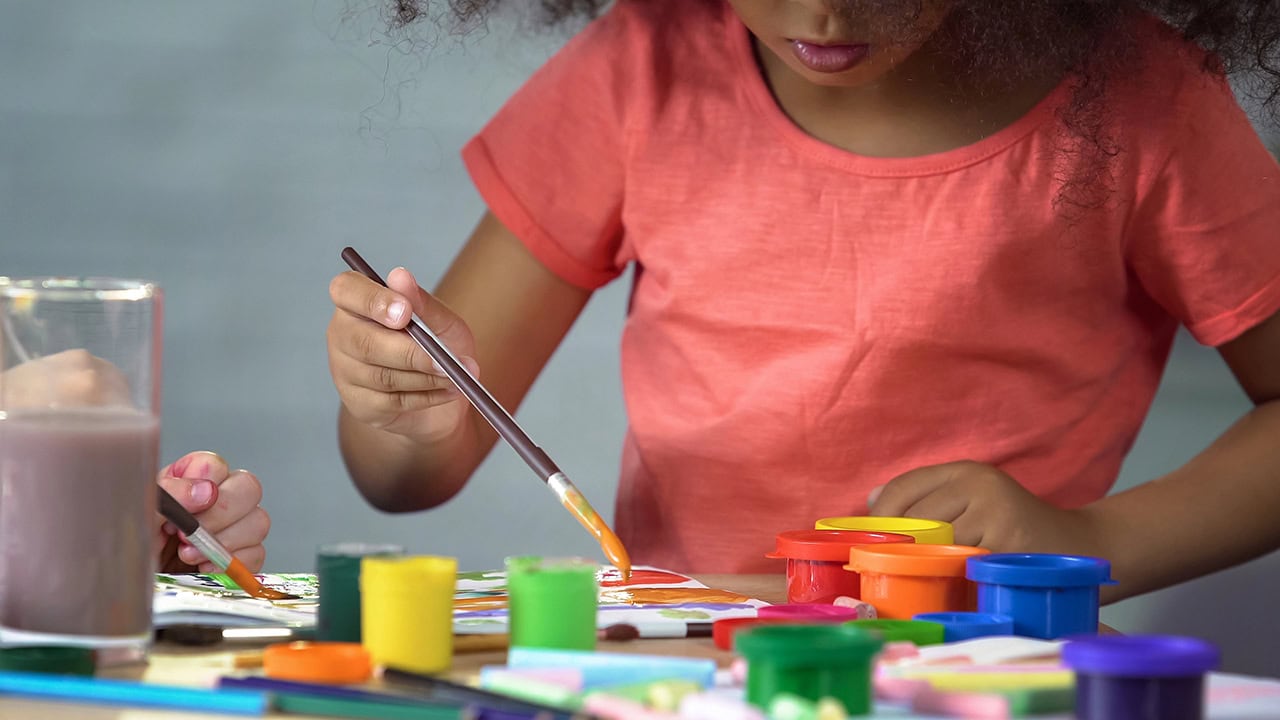 African American girl painting at New Jersey art class. Image produced by More Jersey.