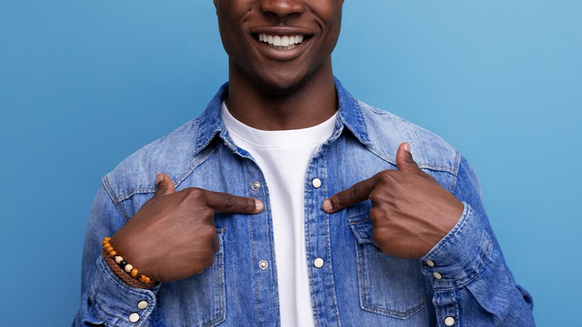 African American resident confidently pointing at their chest.