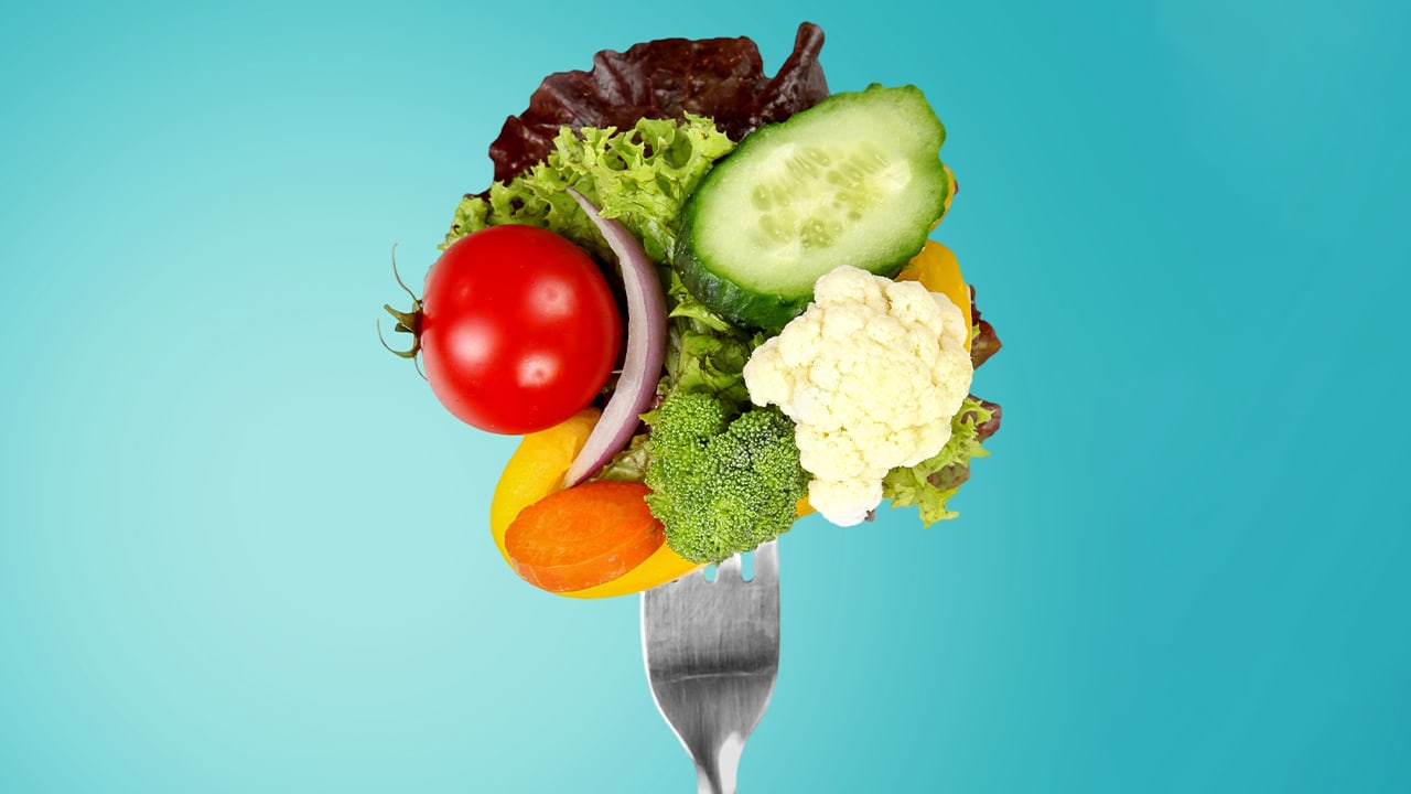 Assortment of fresh raw vegetables on a fork.