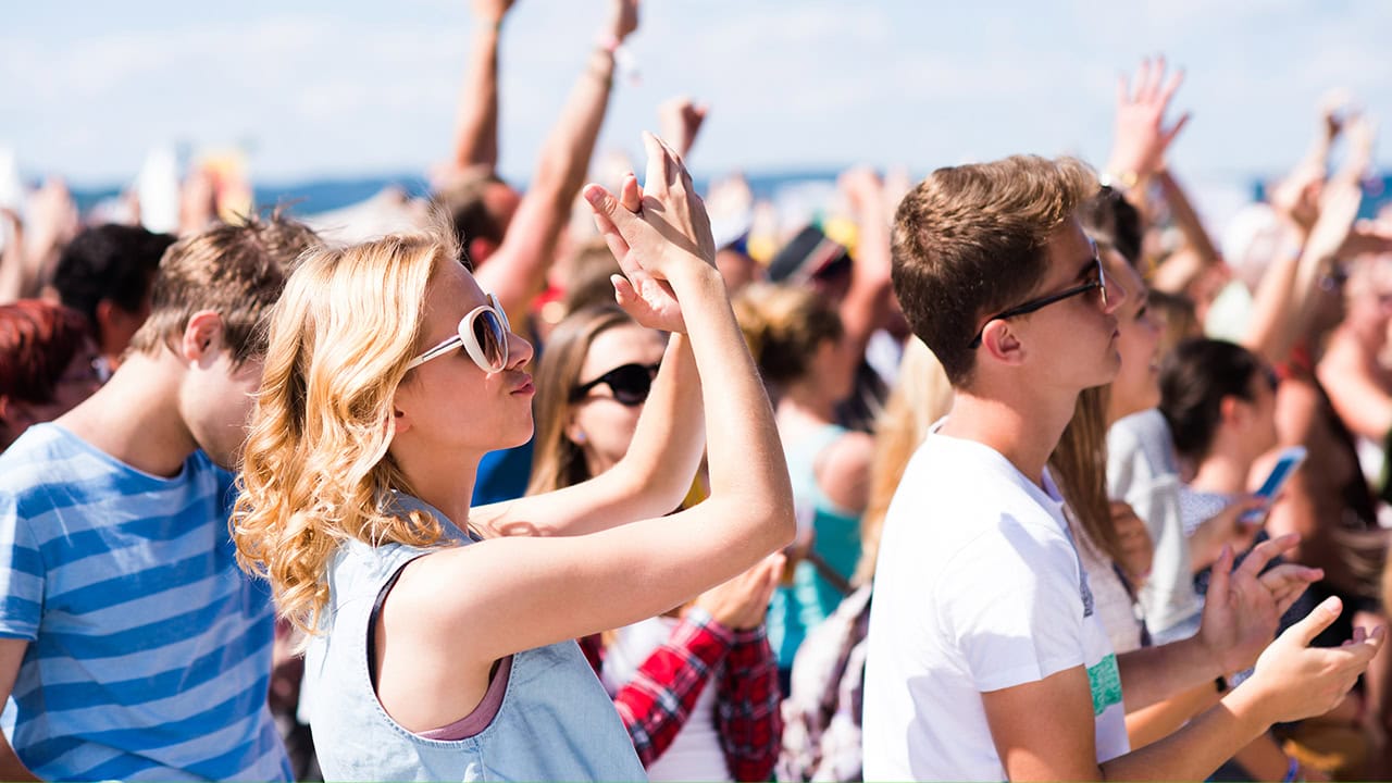 Audience of teens enjoying music at New Jersey musical festival. Image produced by More Jersey.