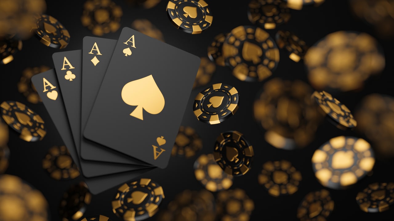 Black and gold poker cards and casino chips. Image produced by More Jersey.