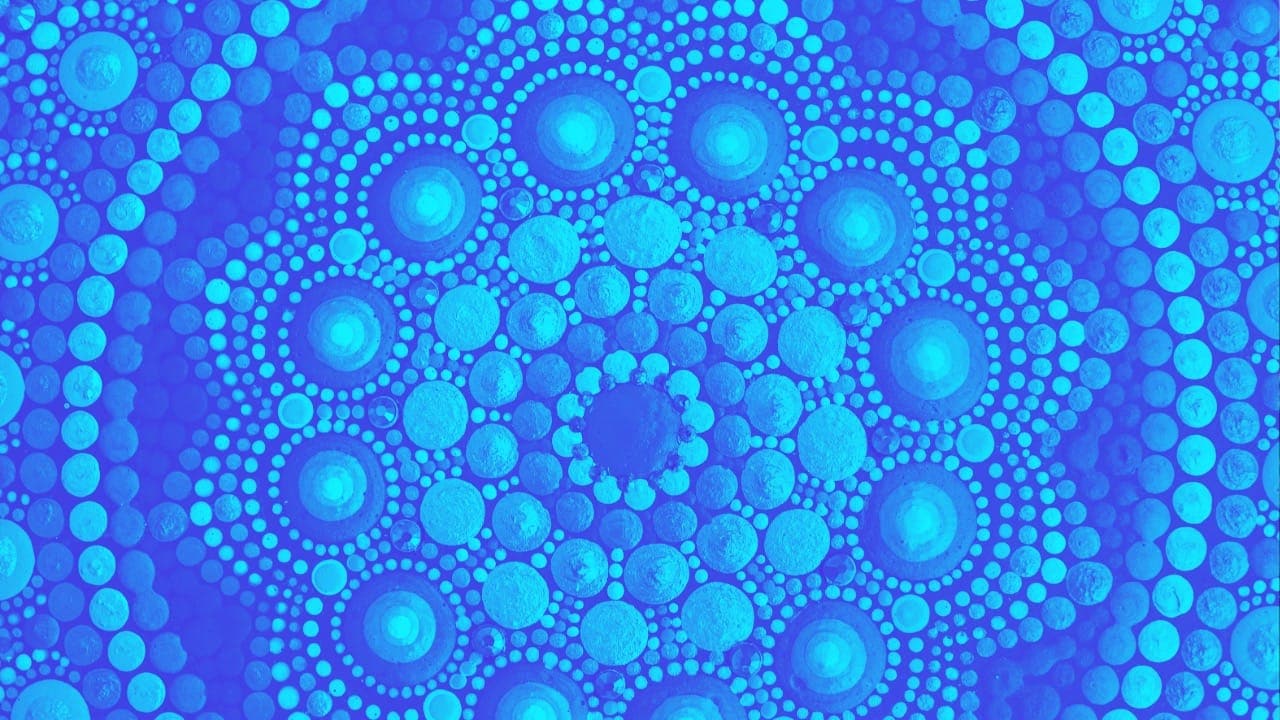 Blue Mandala-style dot painting pattern.