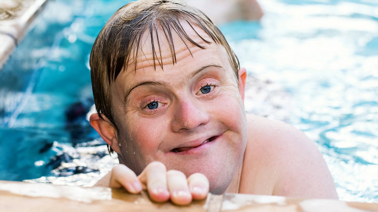 Boy with Down syndrome swimming at a local swimming pool. Image produced by More Jersey.