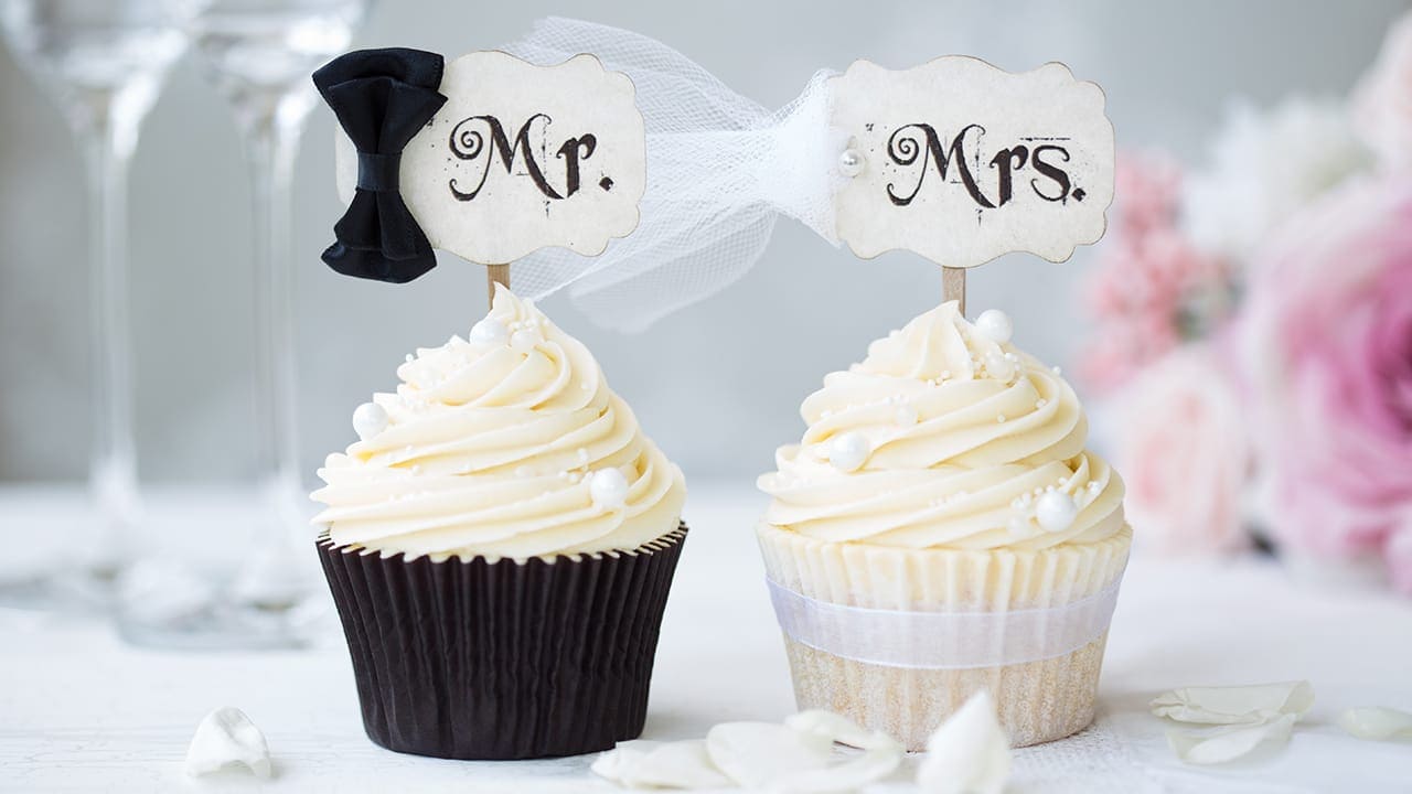 Bride and groom decorated cupcakes.