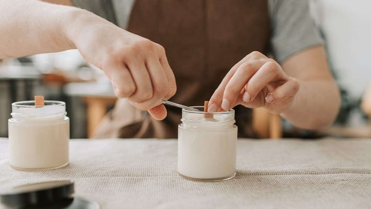 Candle making class participant cutting wick. Image produced by More Jersey.