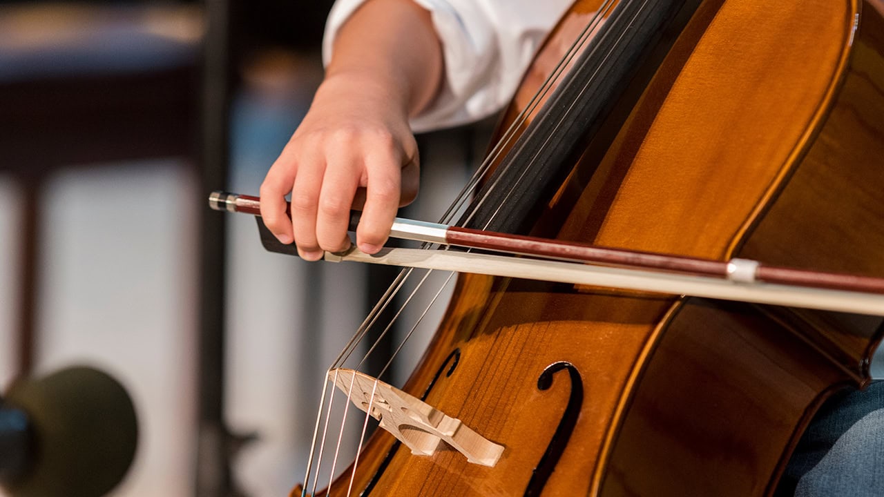 Cello player performing during live performance. Image produced by More Jersey.