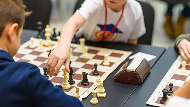 Children playing in New Jersey youth chess tournament.