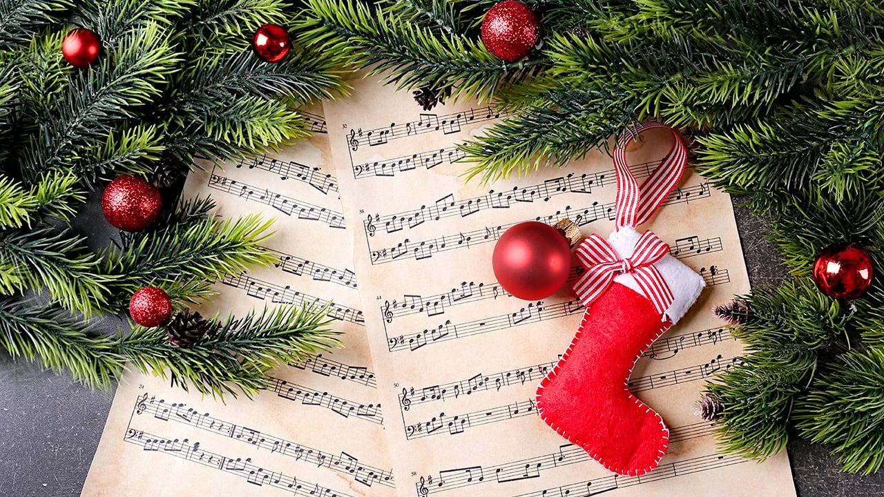 Christmas sheet music along with holiday decorations. Image produced by More Jersey.