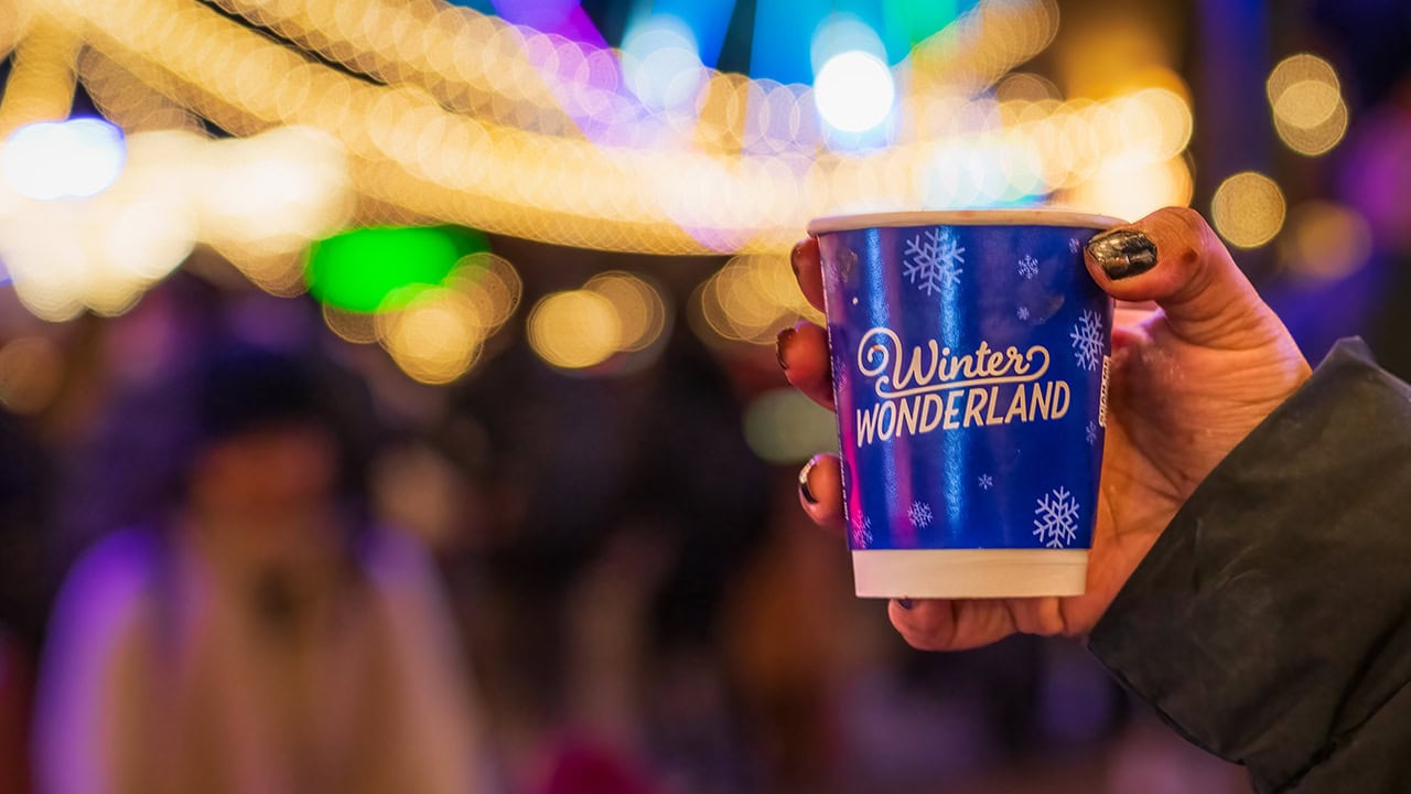 Close-up of hand holding winter wonderland cup. Image produced by More Jersey.