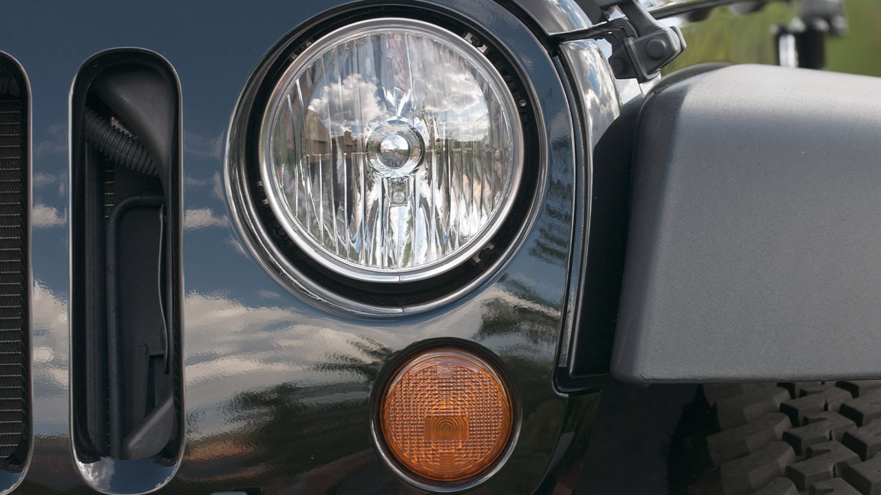 Close-up of Jeep fender, headlight, and grill at New Jersey jeep event. Image produced by More Jersey.