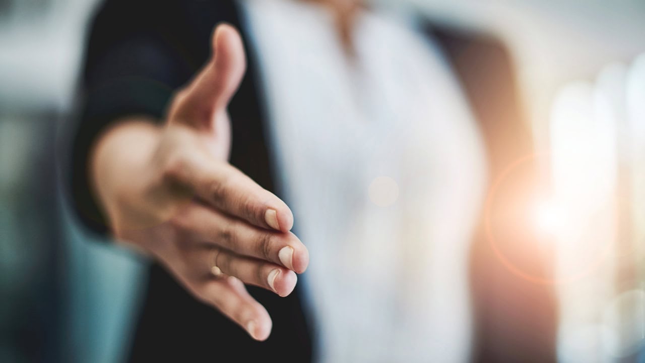 Close-up of person extending their hand for a handshake. Image produced by More Jersey.