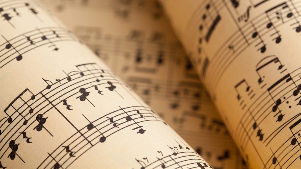 Close-up photograph of rolled-up sheet music.