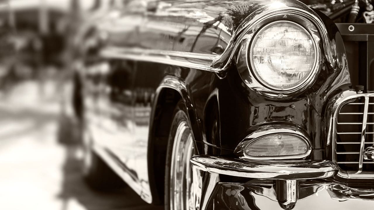 Close-up vintage photo of shiny classic car front and passenger side from New Jersey car show.