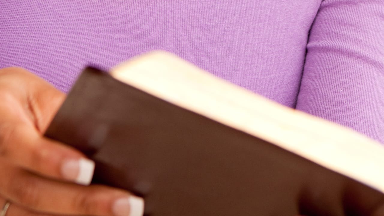 Close-up of African-American woman reading the bible.