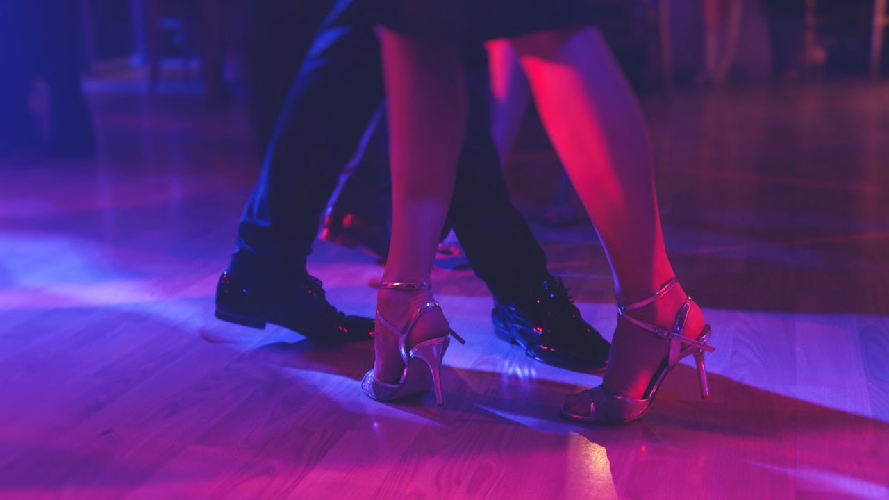 Close-up of instructor couple teaching Traditional Latin dance class. Image produced by More Jersey.