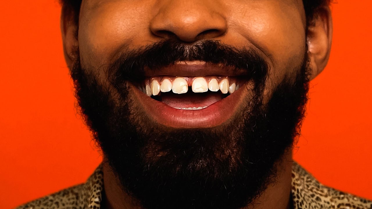 Close-up of man laughing at comedian. Image produced by More Jersey.