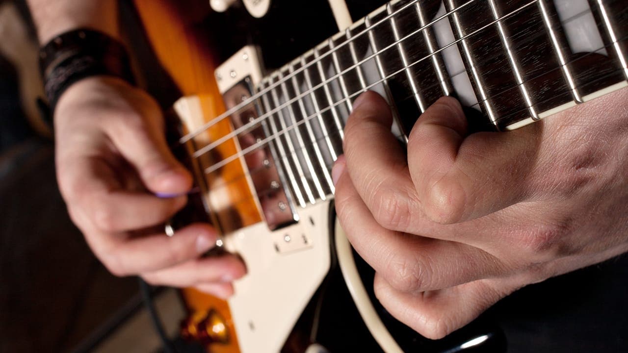 Closeup of New Jersey musician playing electric guitar.