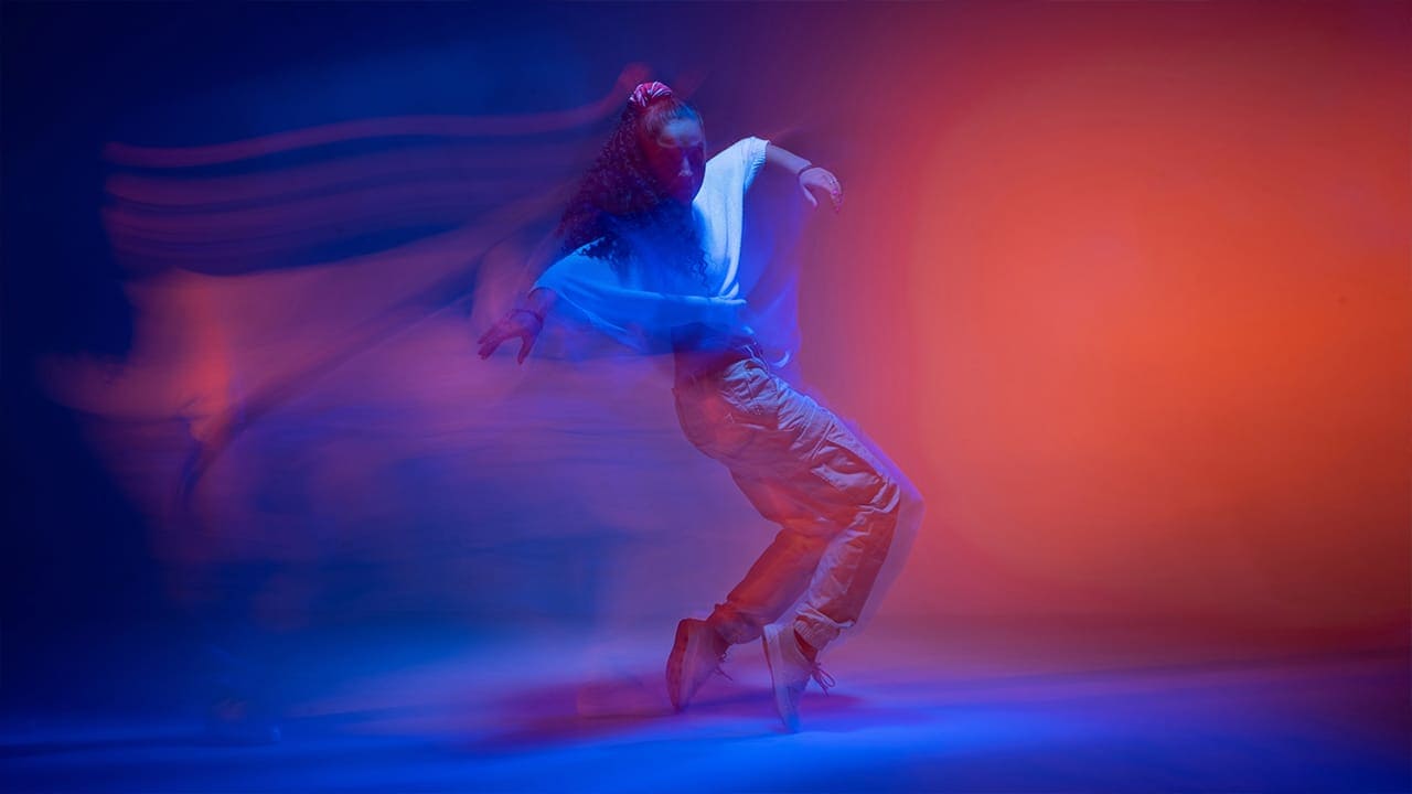 Colorful neon long exposure photo of a dancing female.