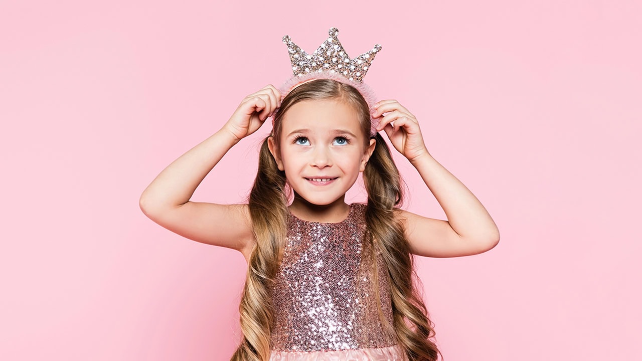 Cute little girl wearing a tiara princess crown. Image produced by More Jersey.