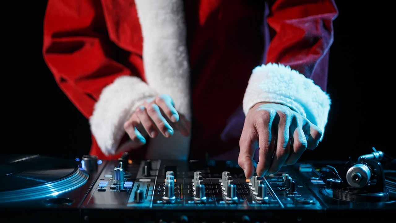 DJ wearing Santa Claus costume at New Jersey Christmas dance party. Image produced by More Jersey.