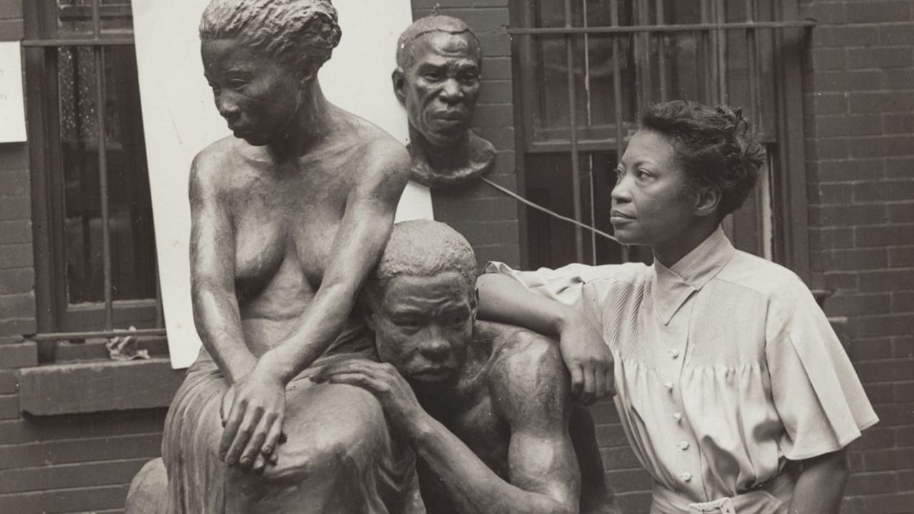 Famous Harlem Renaissance artist Augusta Savage with her sculpture entitled Realization.
