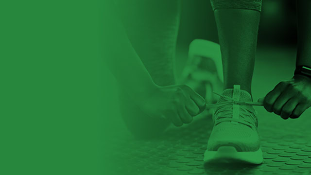 Female New Jersey resident tying shoelaces before fitness training workout.