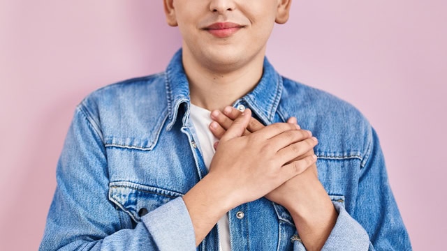 Young Queer resident with hands over heart gesturing they care about opportunities to Give Local in New Jersey.