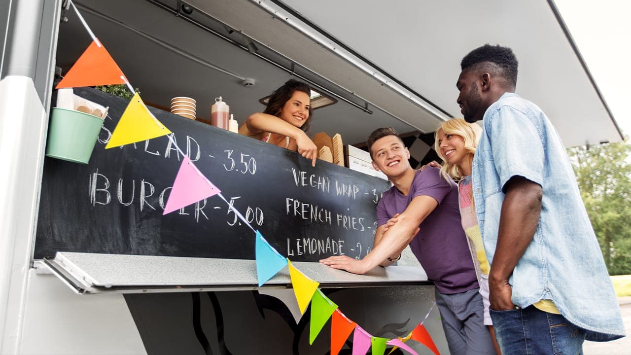 Group of friends ordering food at New Jersey food truck.