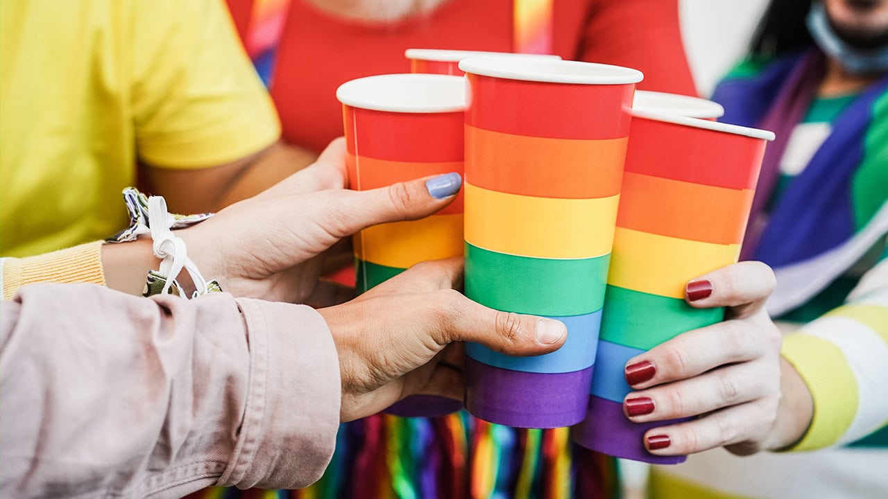 Group of residents touching rainbow cups for cheers at NJ Pride event.