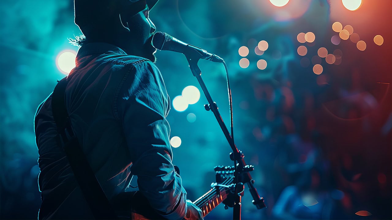 Guitarist singing at a late night concert in New Jersey. Image produced by More Jersey.