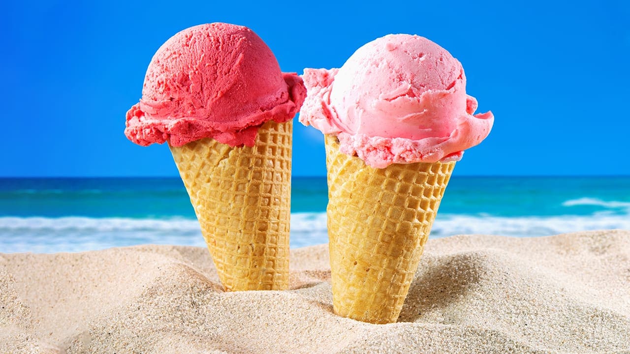 Ice cream cones sitting in sand at the Jersey Shore.