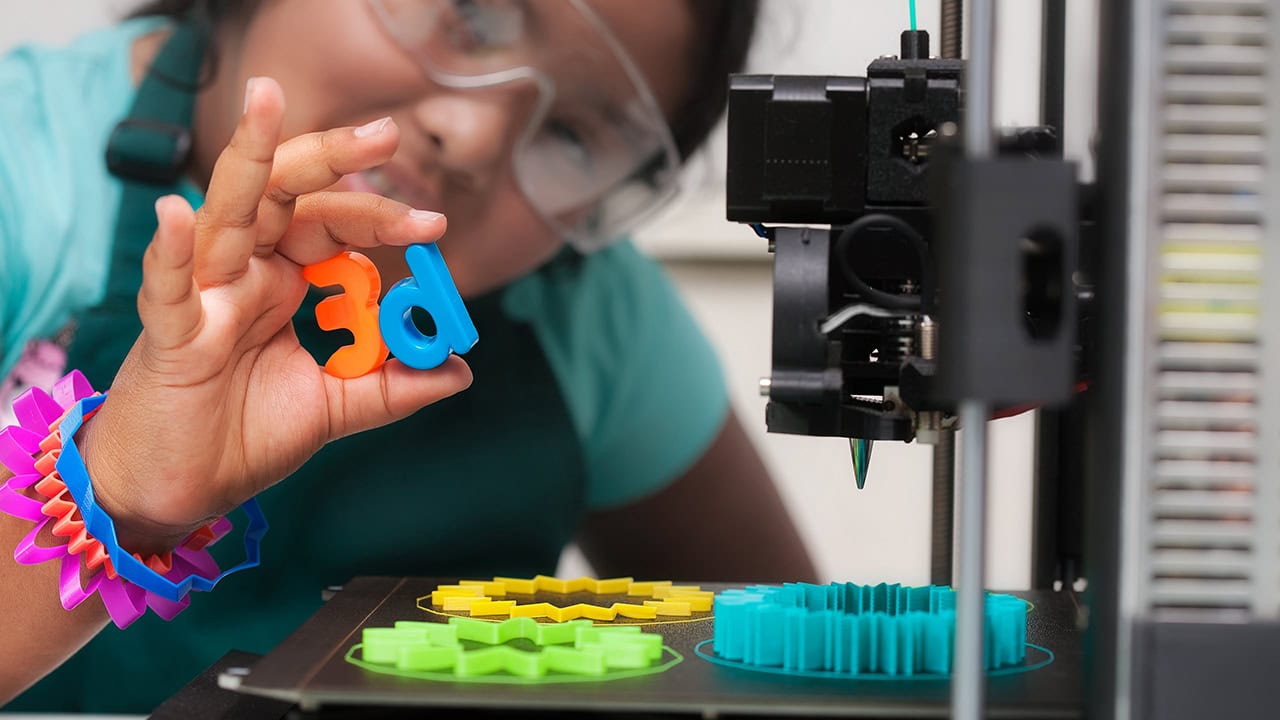 Latino female student using 3D printer Image produced by More Jersey.