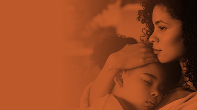 Latino mother comforting daughter as she sleeps on the mother's chest.