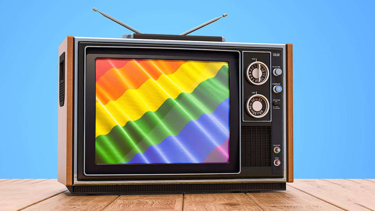 LGBTQA+ flag playing on vintage television.