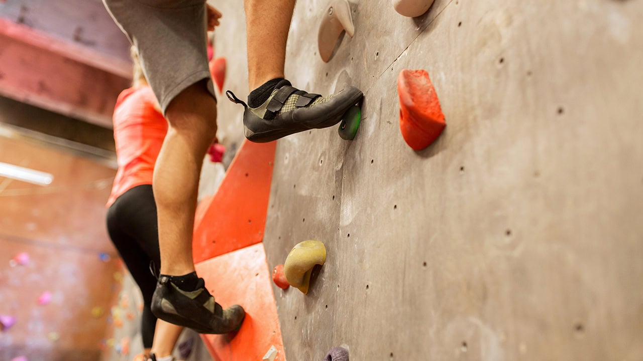 Man and woman indoor rock climbing. Image produced by More Jersey.