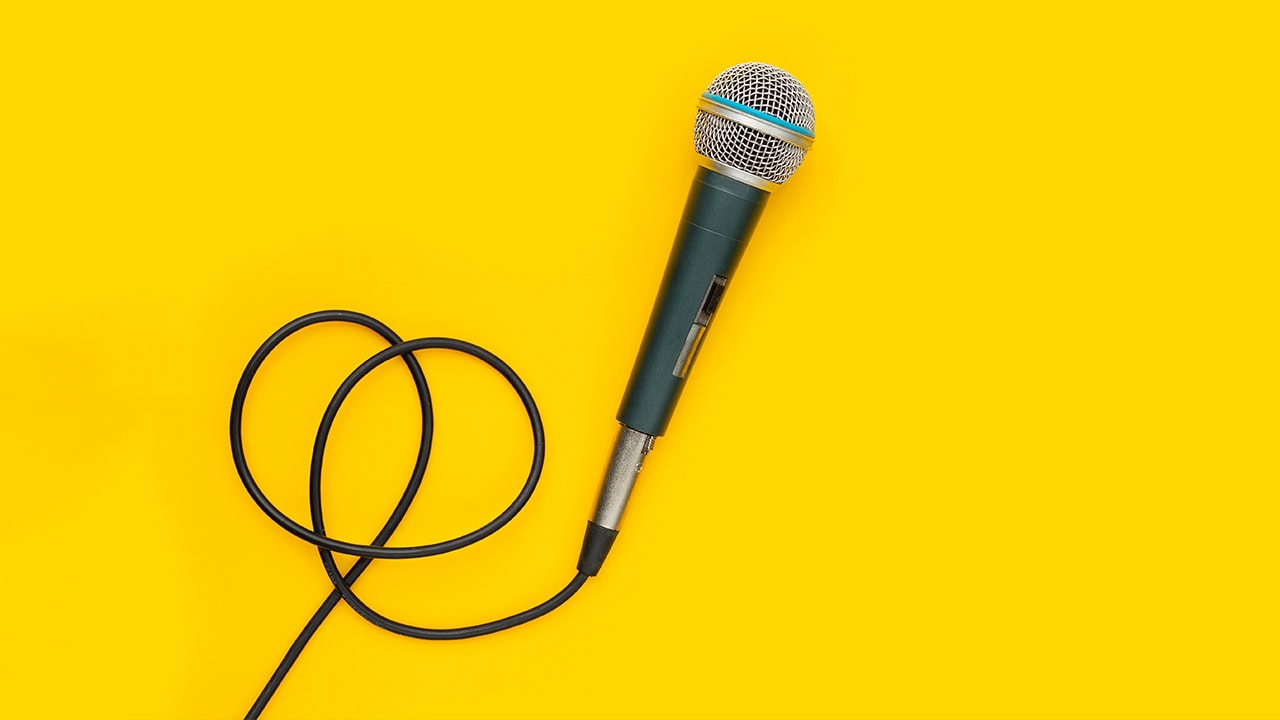 Microphone with chord on yellow background. Image produced by More Jersey.