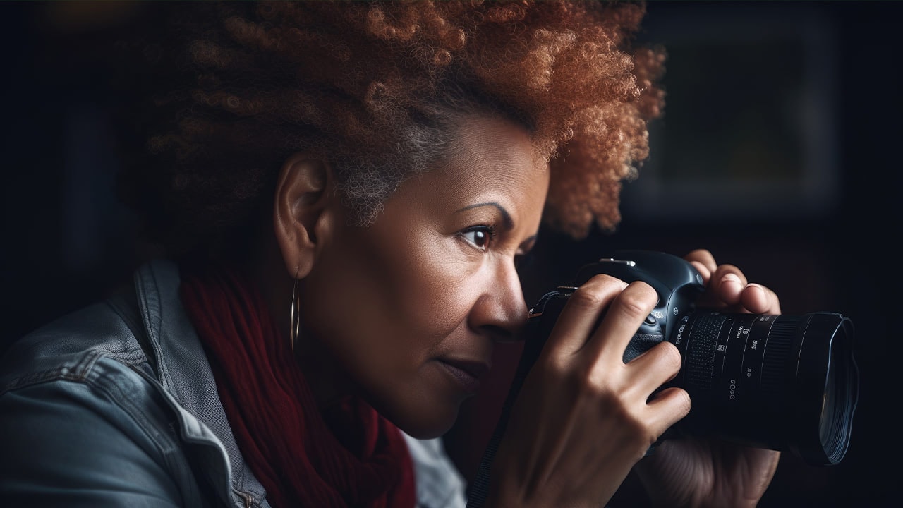 Middle age African American female photographer with a professional digital camera.