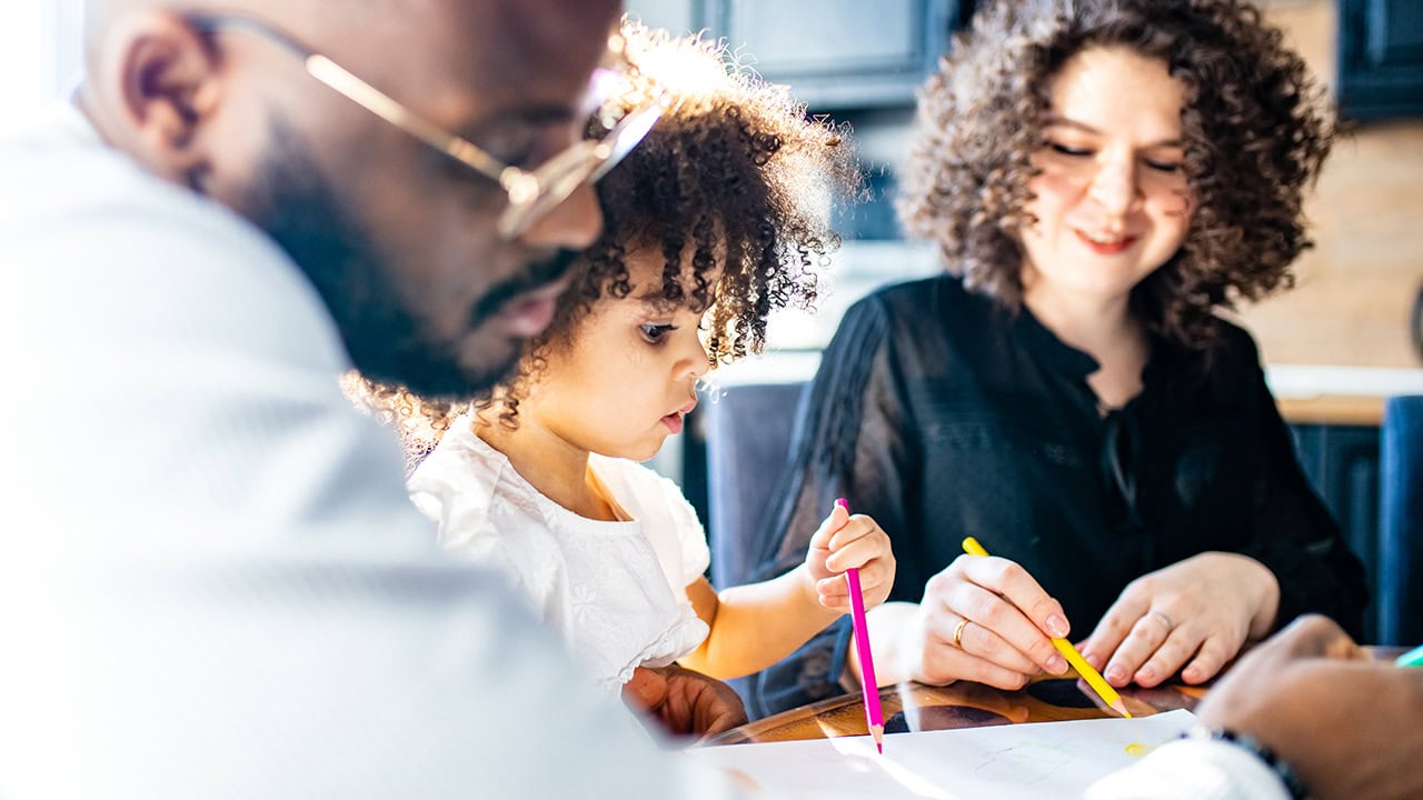 Multiracial Hispanic family drawing with coloring pencils in kitchen. Image produced by More Jersey.