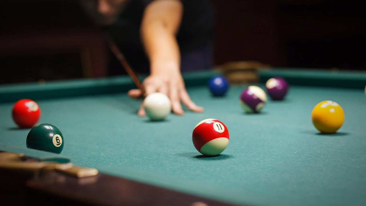 Resident playing billiards at a New Jersey billiard hall.