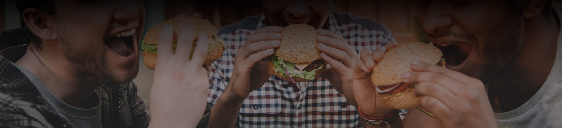 Three guys holding savory burgers at New Jersey food event.