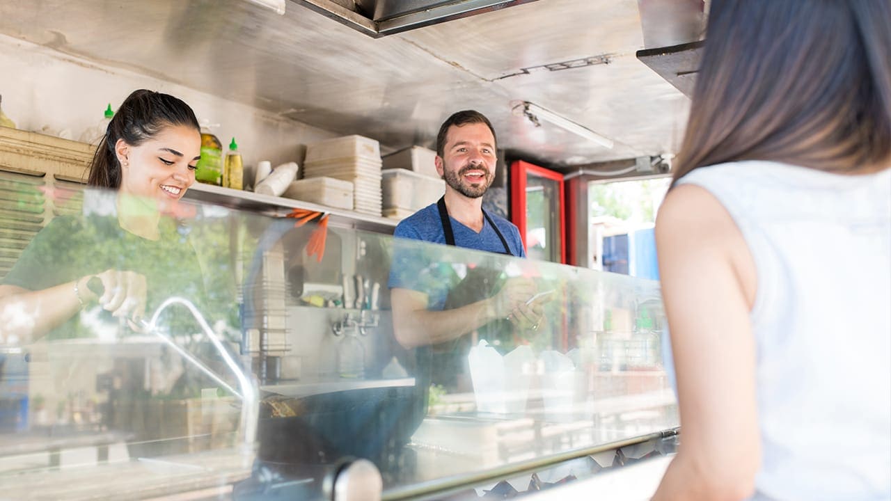 New Jersey food truck owner talking with customer.