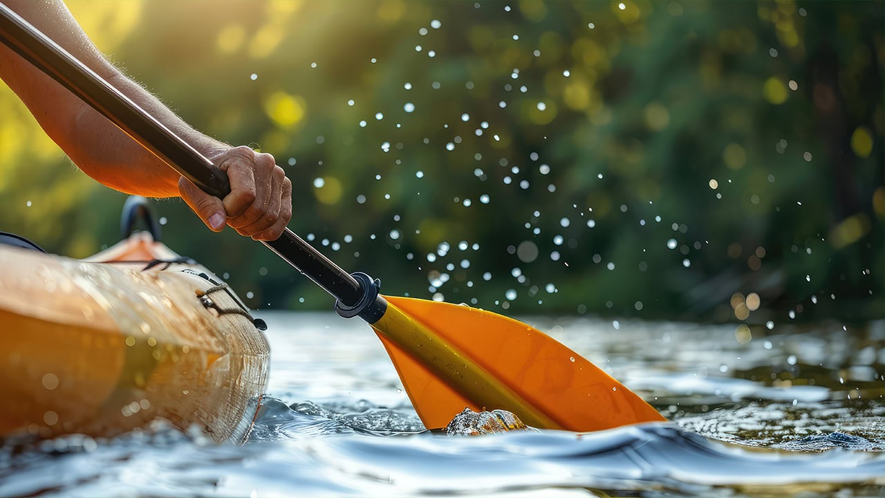 Close-up of a New Jersey resident kayaking down a river. 