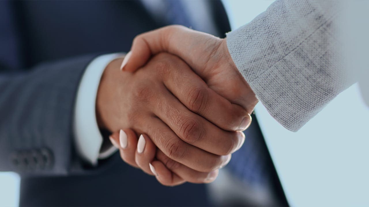 New Jersey male and female professionals shaking hands.