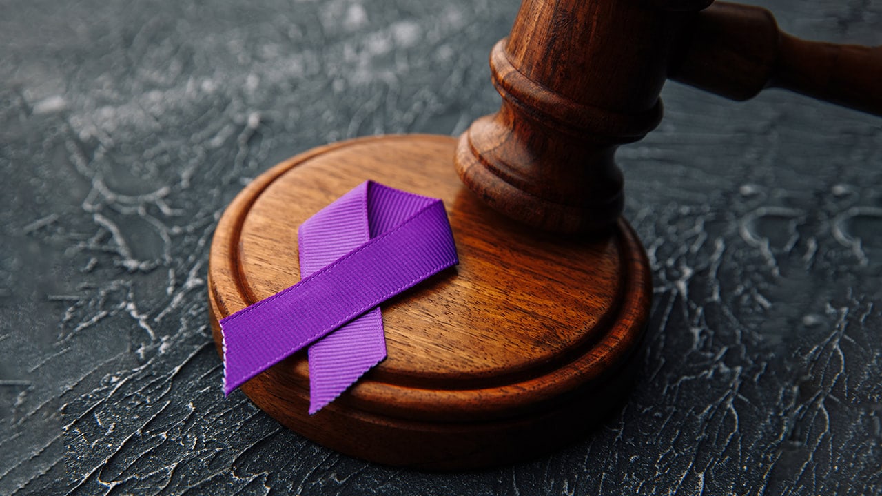 Photo of a purple Domestic Violence ribbon and gavel.