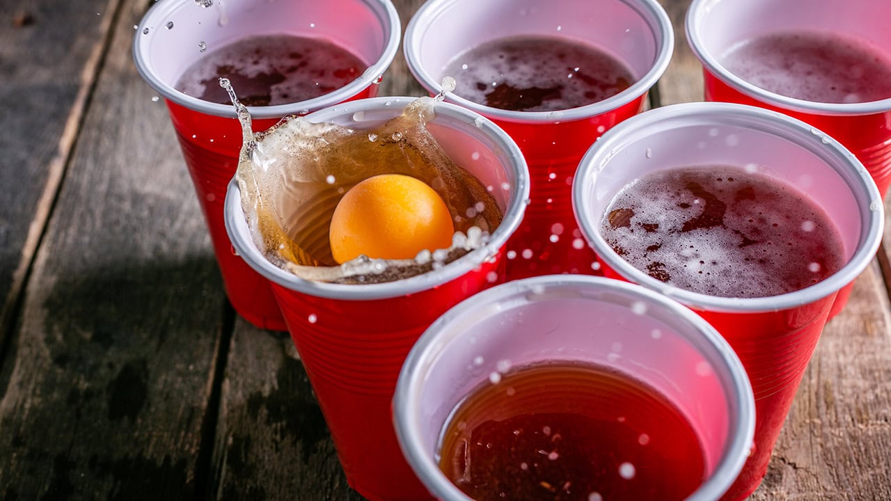 Pong creating splash in red cup during a beer pong competition. Image produced by More Jersey.