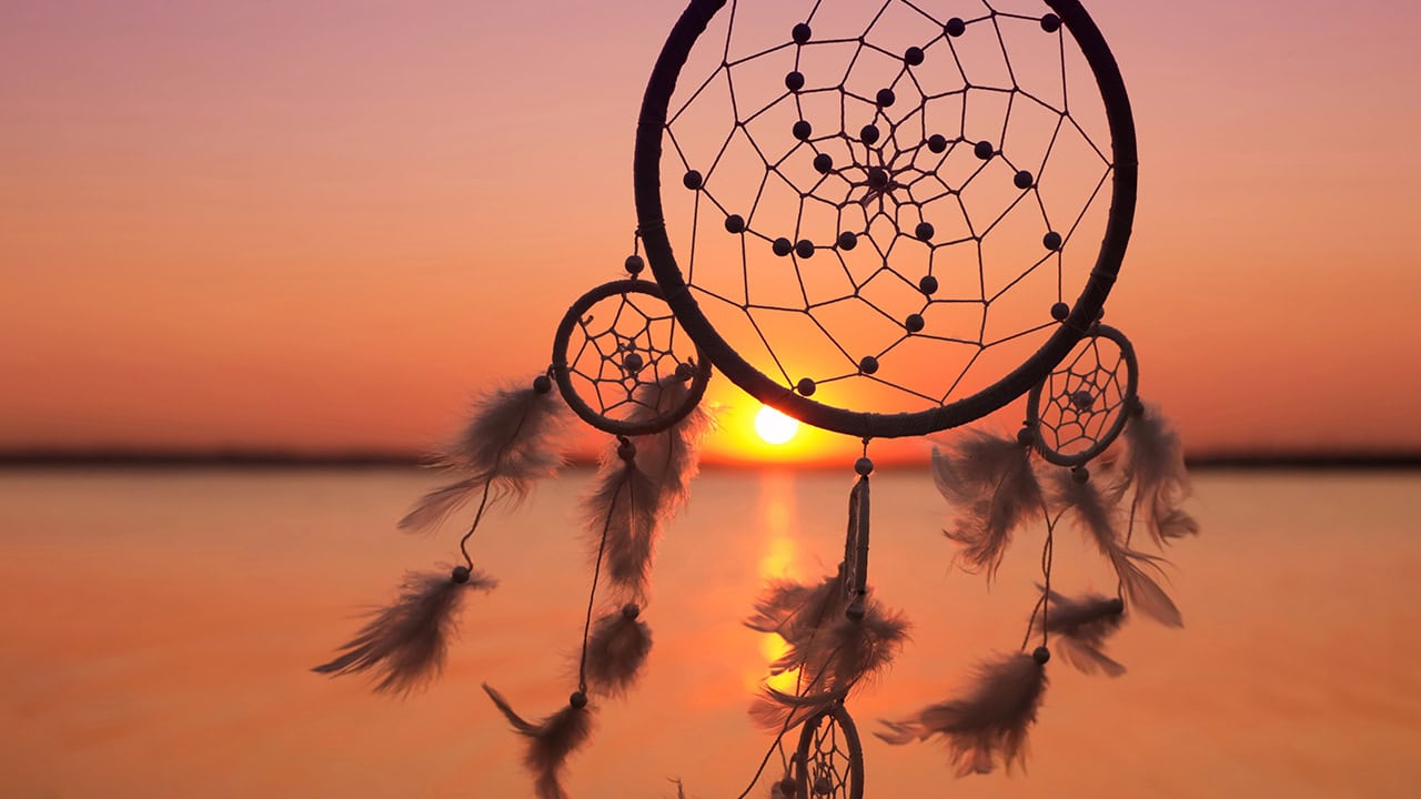 Professional photograph of dream catcher with sunset in background. Image produced by More Jersey.