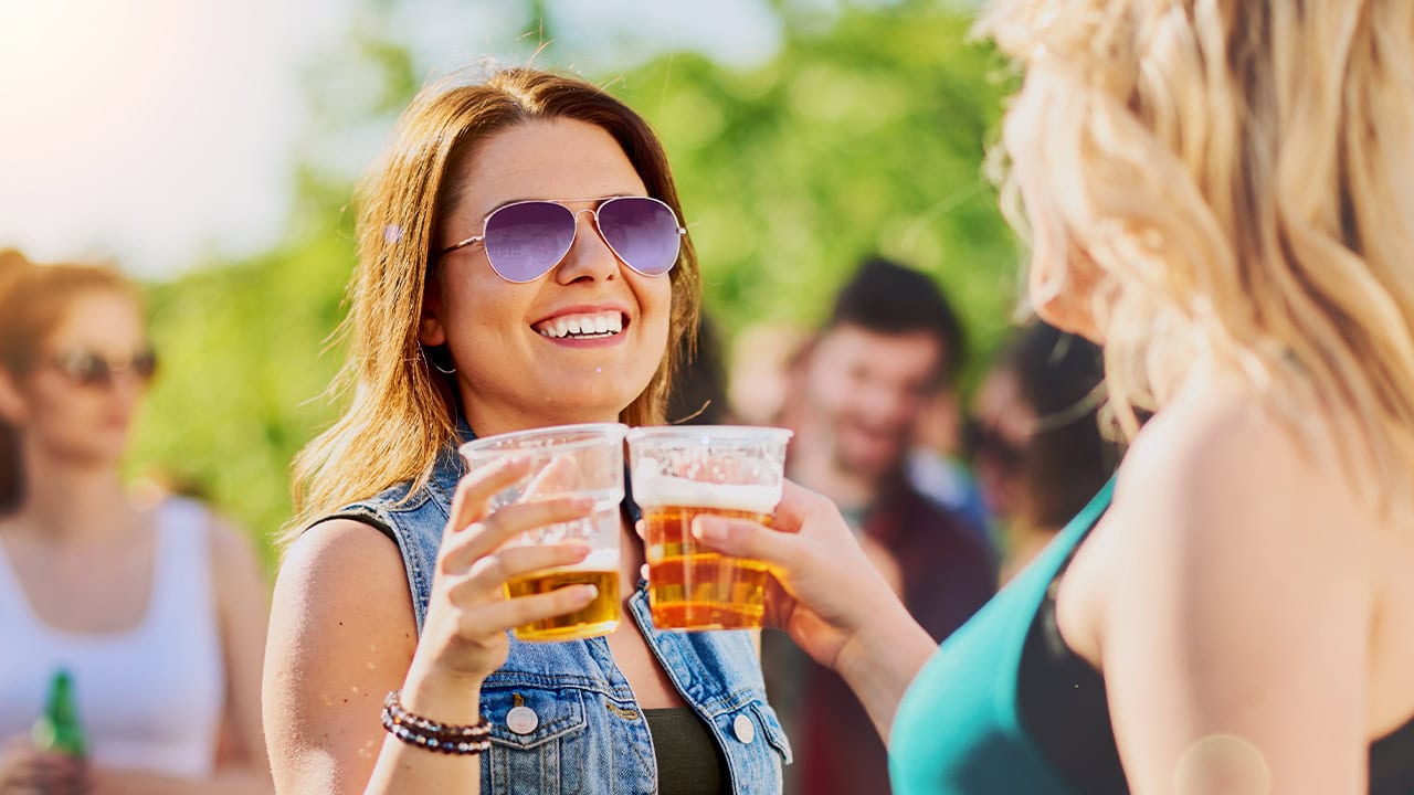 Residents enjoying outdoor beer and wine festival.