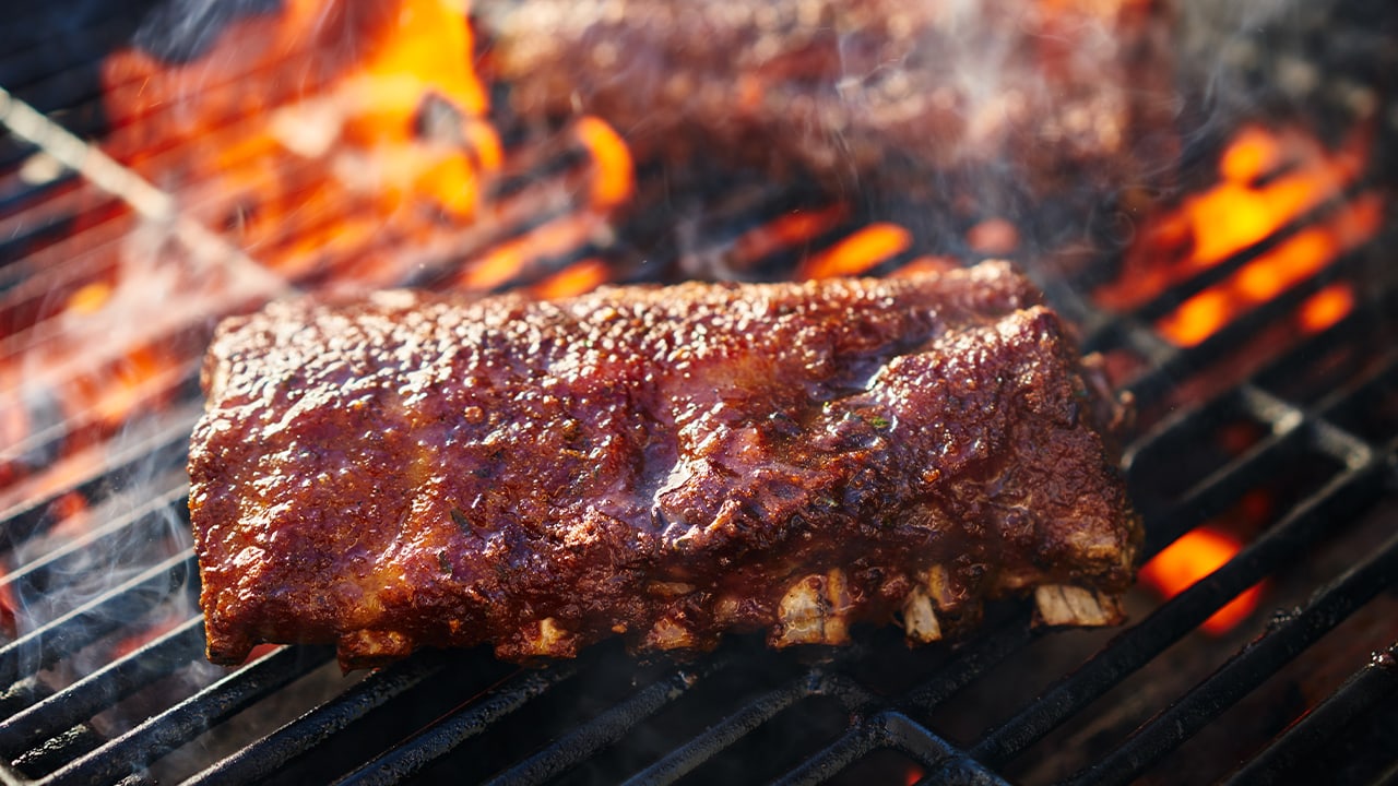 Ribs being flame grilled at New Jersey BBQ event.