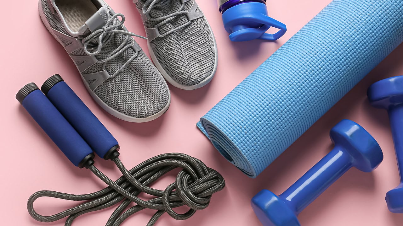 Running shoes and sports equipment on a pink color background. Image produced by More Jersey.