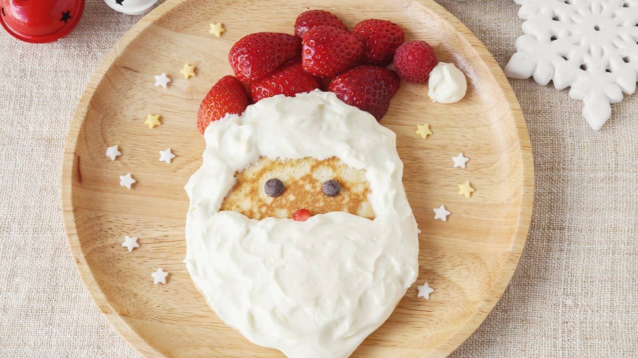 Santa Claus pancake made with fresh strawberries and whipped cream.